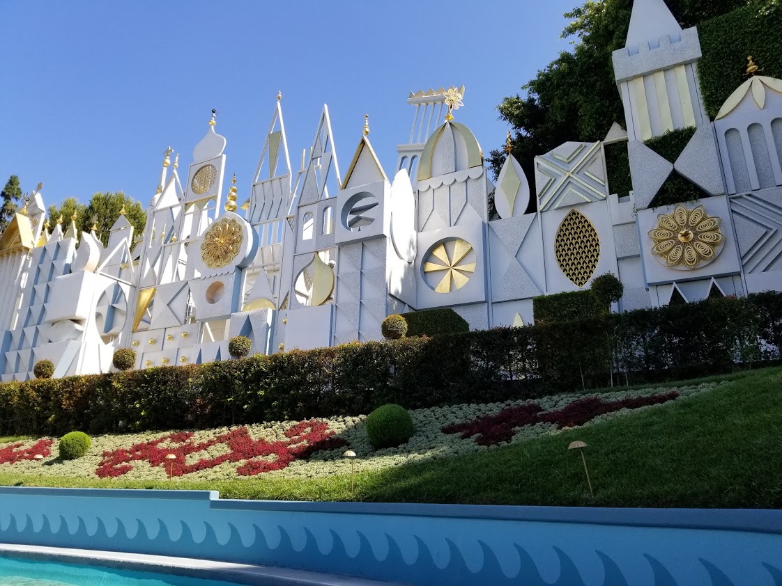 A decorative white and gold wall shaped like towers and turrets in Disneyland.